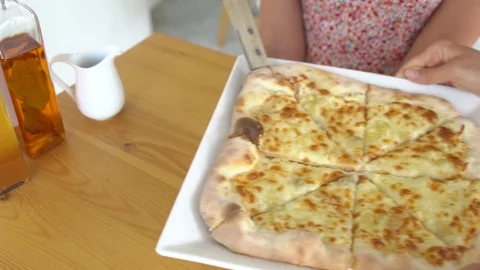 Waiter serving cheese pizza Stock Footage 77577536
