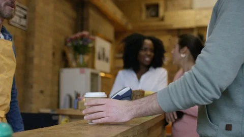 Waiter serving coffee and taking orders from customers at bike garage cafe Video stock 108035215