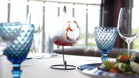 A waiter serving a customer in a restaurant. Close-up of a waiter putting a Stock-Footage 156440300