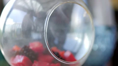 A waiter serving a customer in a restaurant. Close-up of a waiter putting a Stock Footage 172358080