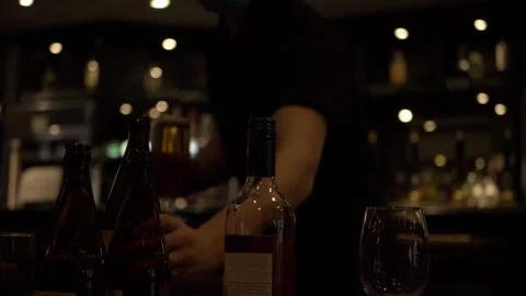 Waiter serving drinks and bottles in a bar medium panning shot Stock Footage 143234800