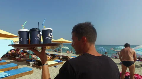 Waiter serving drinks, caffee, cocktails on the beach Stock Footage 66655243
