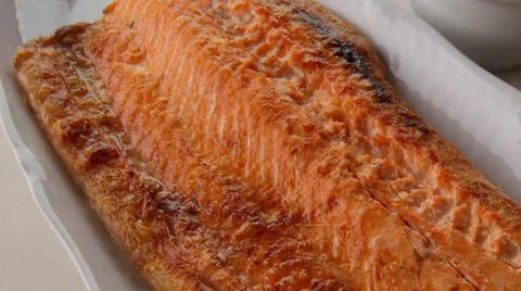 Waiter serving grilled salmon at the restaurant Stock Footage 30698798