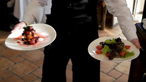 Waiter serving in motion on duty in restaurant Video stock 125814902