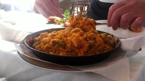 Waiter serving paella in the pan Stock Footage 22133442
