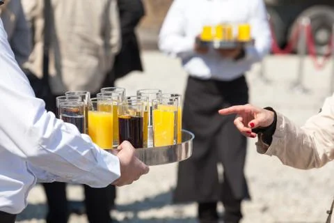 Waiter serving soft drinks at a party Stock Photos
