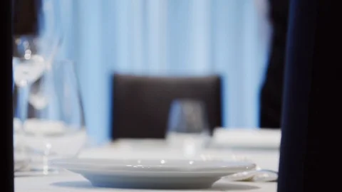 The waiter is serving a table in the restaurant. Stock Footage 113848921