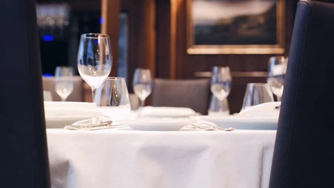 The waiter is serving a table in the restaurant. Stock Footage 113852546