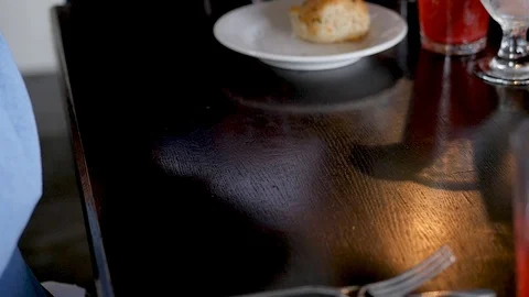 Waiter sets down fish tacos and filet mignon on table Stock Footage 94239350