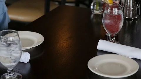 Waiter sets down speciality roles on restaurant table slow motion Stock-Footage 94239563