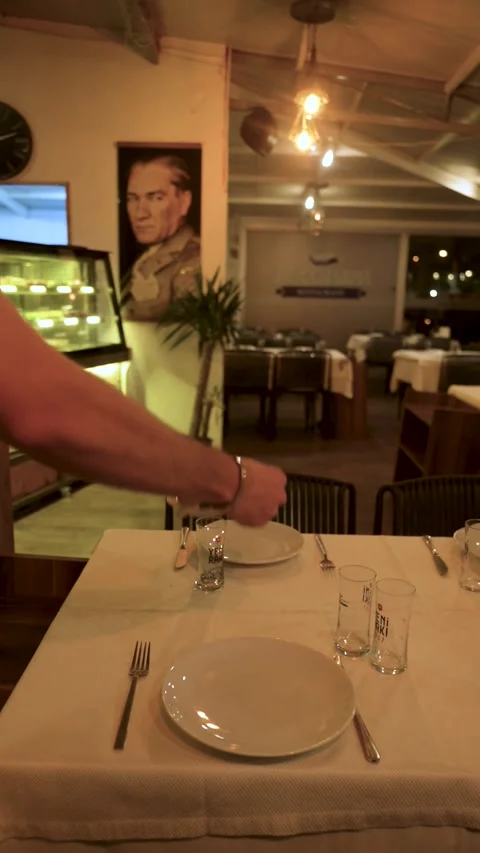 Waiter setting a dinner table in a restaurant, İzmir, Turkey December 8, 2023 스톡 동영상 332117070