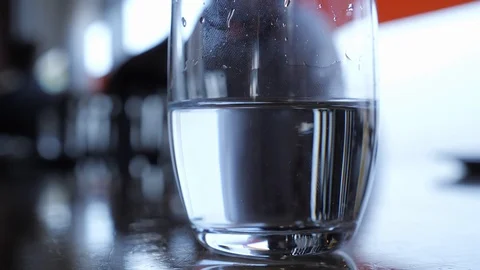 Waiter setting plates in background of water glass in restuarant Stock Footage 102800182