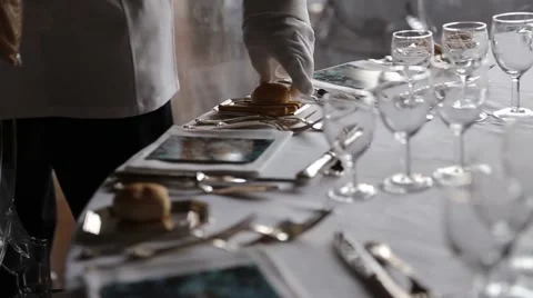 Waiter is setting the table for the evening event Stock Footage 50551320