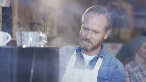 Waiter smiling at camera while preparing coffee at cafe Stock Footage 108014025