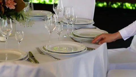 Waiter sorting forks during table setting on pergallo Stock Footage 133789689