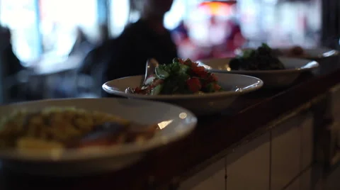 Waiter taking dishes from kitchen, close up, shallow focus Stock Footage 50039203