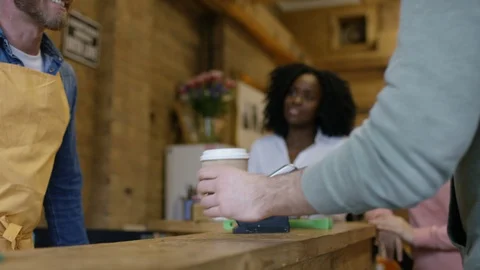 Waiter taking orders, accepting payment and serving coffee at bike garage cafe Stock Footage 108035915