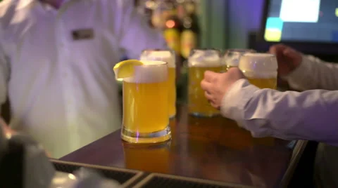 Waiter taking two glasses of beer from table Video stock 61795173