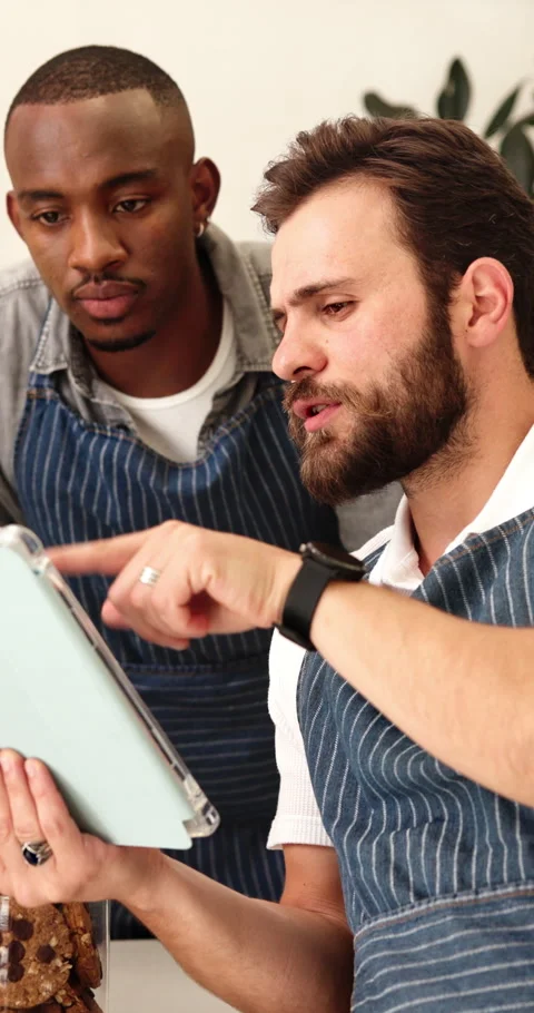 Waiter, team and talking with tablet in cafe for barista training, order entry Stock Footage 339125234