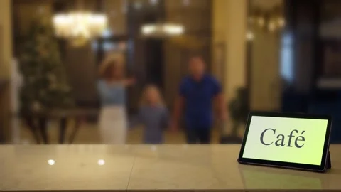 Waiter using display with cafe word on screen. Family approaches to waiter in Stock Footage 267420371