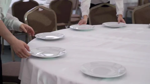 Waiters adjusting plates on the table Video stock 186976129