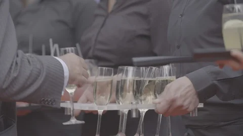 Waiters and waitresses holding drinks at event reception Stock Footage 98694924