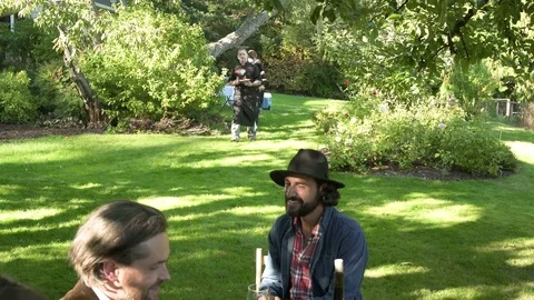 Waiters and waitresses serving meal at an outdoor dinner party 스톡 동영상 77083180