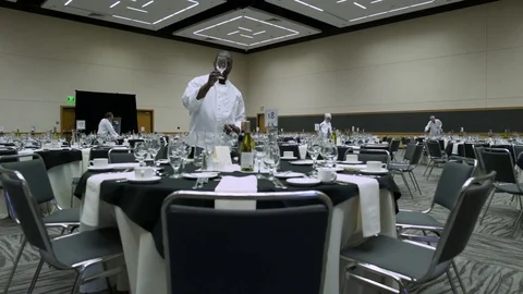 Waiters and waitresses setting tables in a venue Video stock 77081396