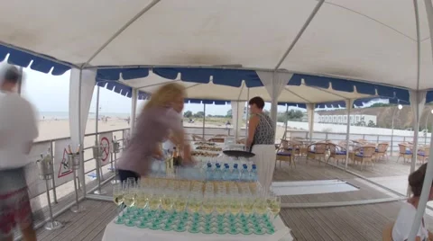 The waiters are poured drinks at summer beach restaurant before the party Stock-Footage 55774420