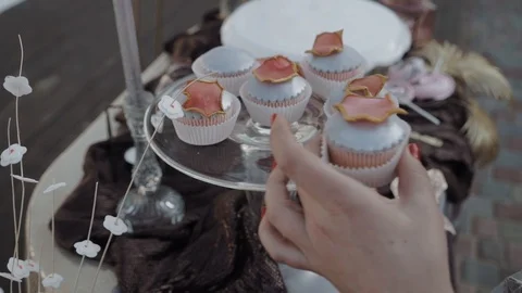 Waiter's hand puts a silvery cake on a candy bar Stock Footage 104760490