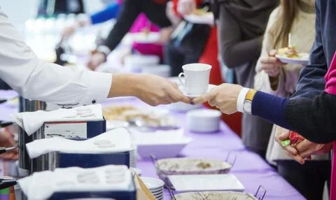 Waiter's hands passing coffee Stock Photos