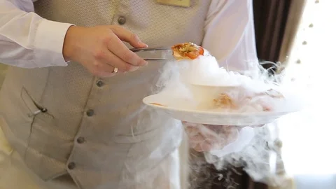 The waiters hands put steaming dish on the plate. Stock Footage 107882274