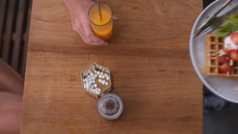 Waiter's hands put on the table waffles with cream and strawberries Stock Footage 101634785