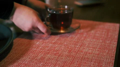 Waiter's job. Women's hands display dessert with fresh strawberries and tea from Stock Footage 153932425