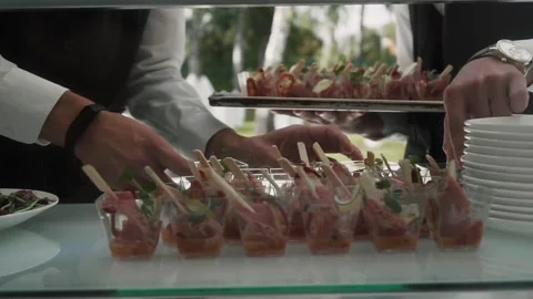 Waiters lay out snacks for buffet Stock Footage 133870882