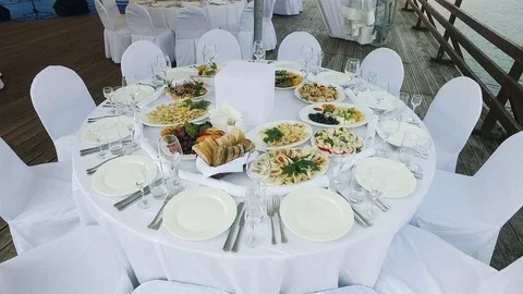 The waiters put on the table plates of food Stock Footage 70366604