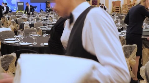 Waiters set the table in a restaurant before customers arrive, and uses fine Stock Footage 117985842