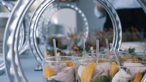The waiters spread beautiful canapes and fruit on the banquet table Stock Footage 102560170