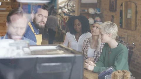Waiters taking order and accepting payments from customers at cafe counter Stock Footage 108023584