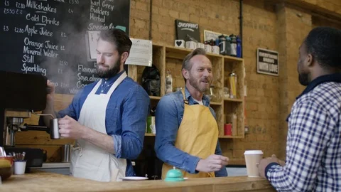 Waiters taking orders, serving coffee and smiling at camera at counter Stock Footage 108037969