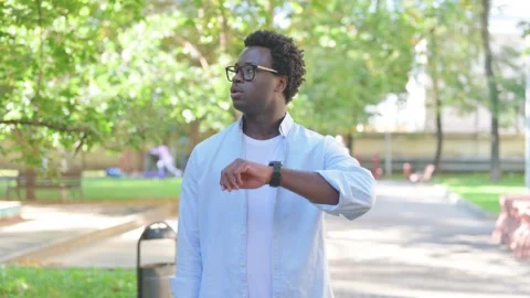 Waiting African Man Checking Time on Writst Watch Outdoor, Portrait Video stock 316806698