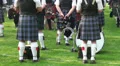 Waiting bagpipe players lower bodies at Highland Gathering HD Footage