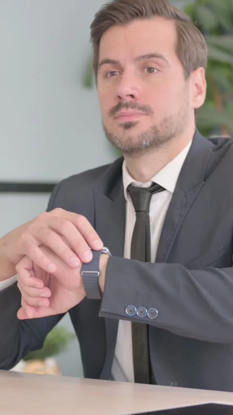 Waiting Businessman Checking Time on Wrist Watch at Work, vertical video Stock Footage 328557187