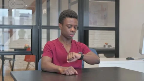 Waiting Casual African Man Checking Time at work Stock Footage 303216513