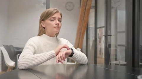 Waiting Creative Young Woman Checking time on Watch at Workplace Stock Footage 303880878