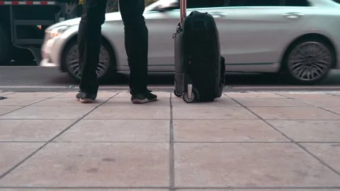 Waiting at the Curb with a Suitcase in Hand Stock Footage 315116871