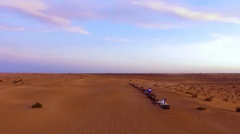 Waiting for the drag race to start in the desert under the sunset Stock Footage 99158550