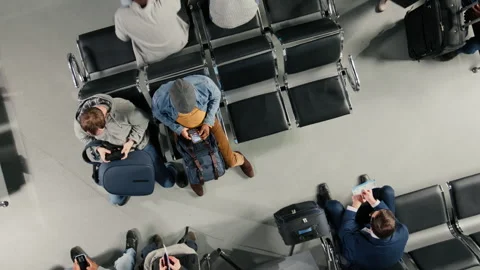 Waiting, flight schedule screen and people in airport lounge Video stock 333650433
