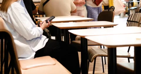 Waiting for an order on the phone at a table in a restaurant Stock Footage 339949905