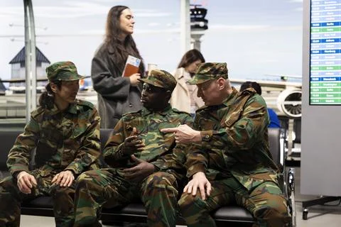 Waiting for plane arrival, troops and military team in airport terminal Stock Photos